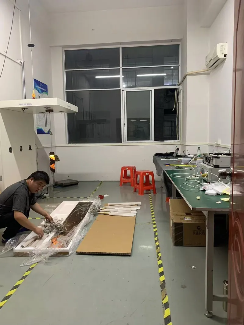 Technician hand-building a lighting sample in the workshop